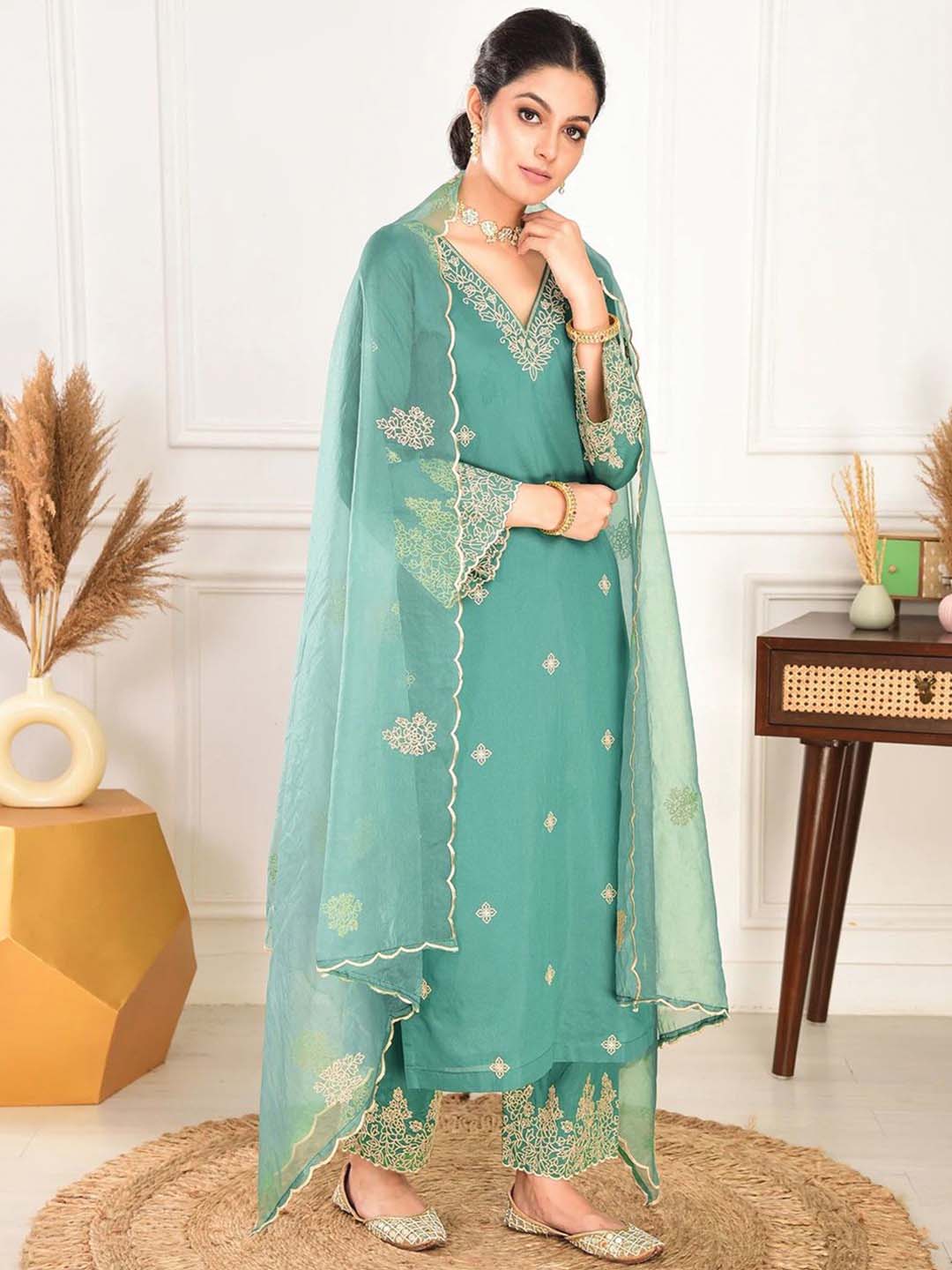 Elegant green embroidered suit with graceful dupatta detailing